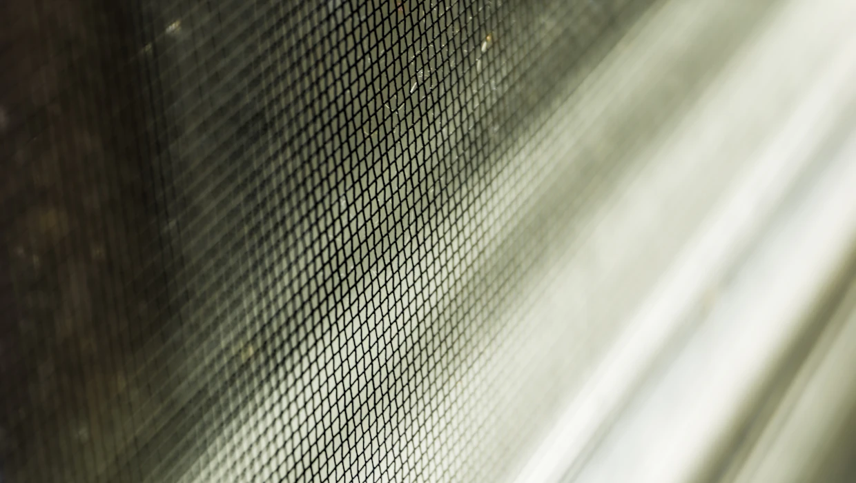 Close-up of standard fiberglass screen weave, the spec behind every quote